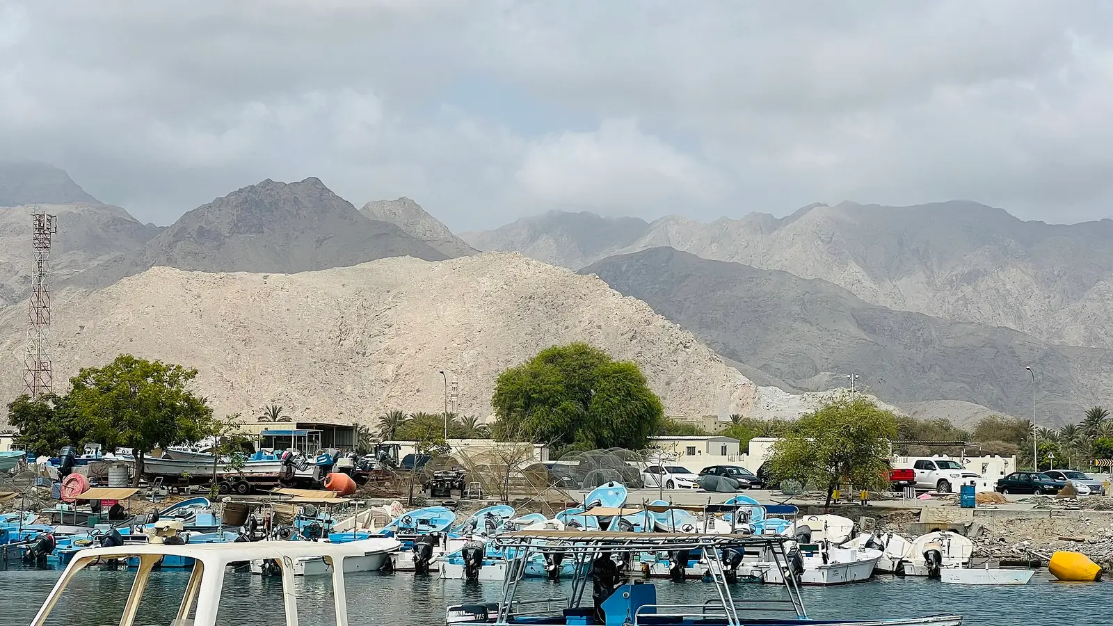 Fishing boats in Fujairah harbour below the Hajar mountains