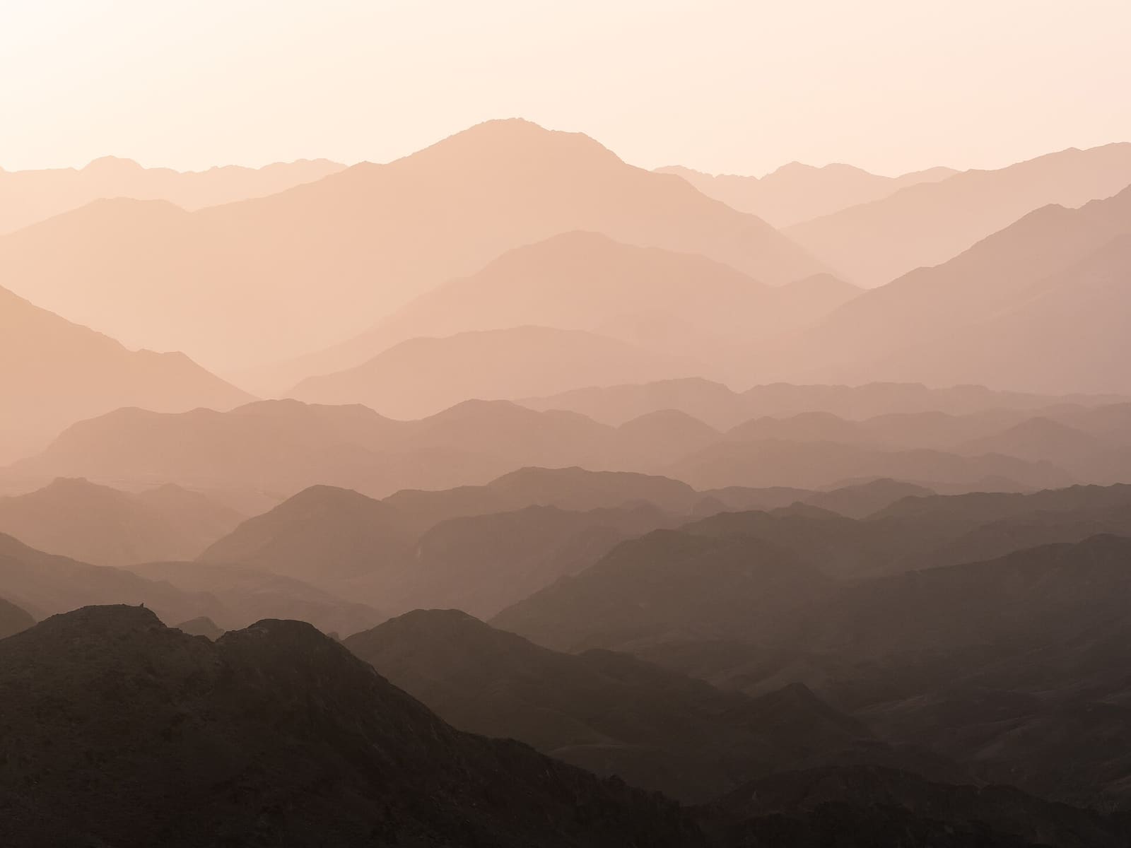 Hajar mountain ridges fading into haze