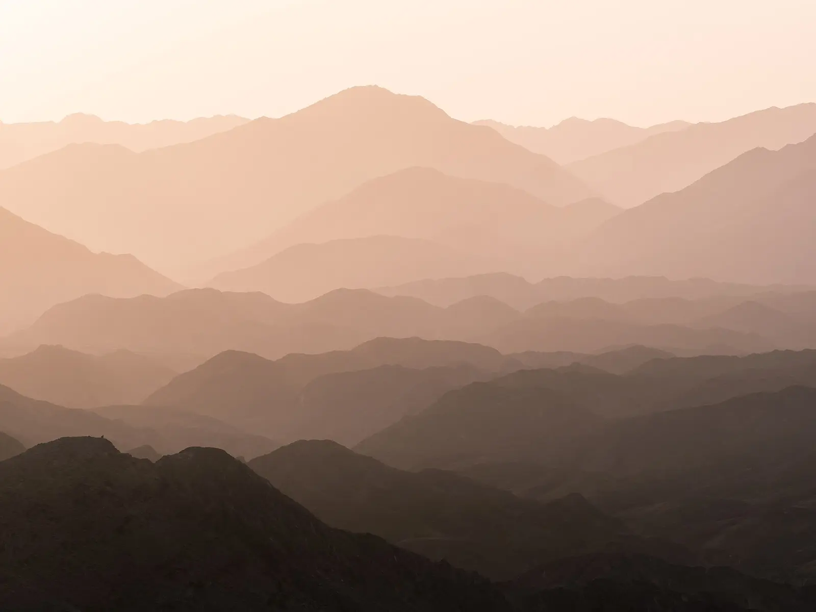 Hajar mountain ridges fading into haze
