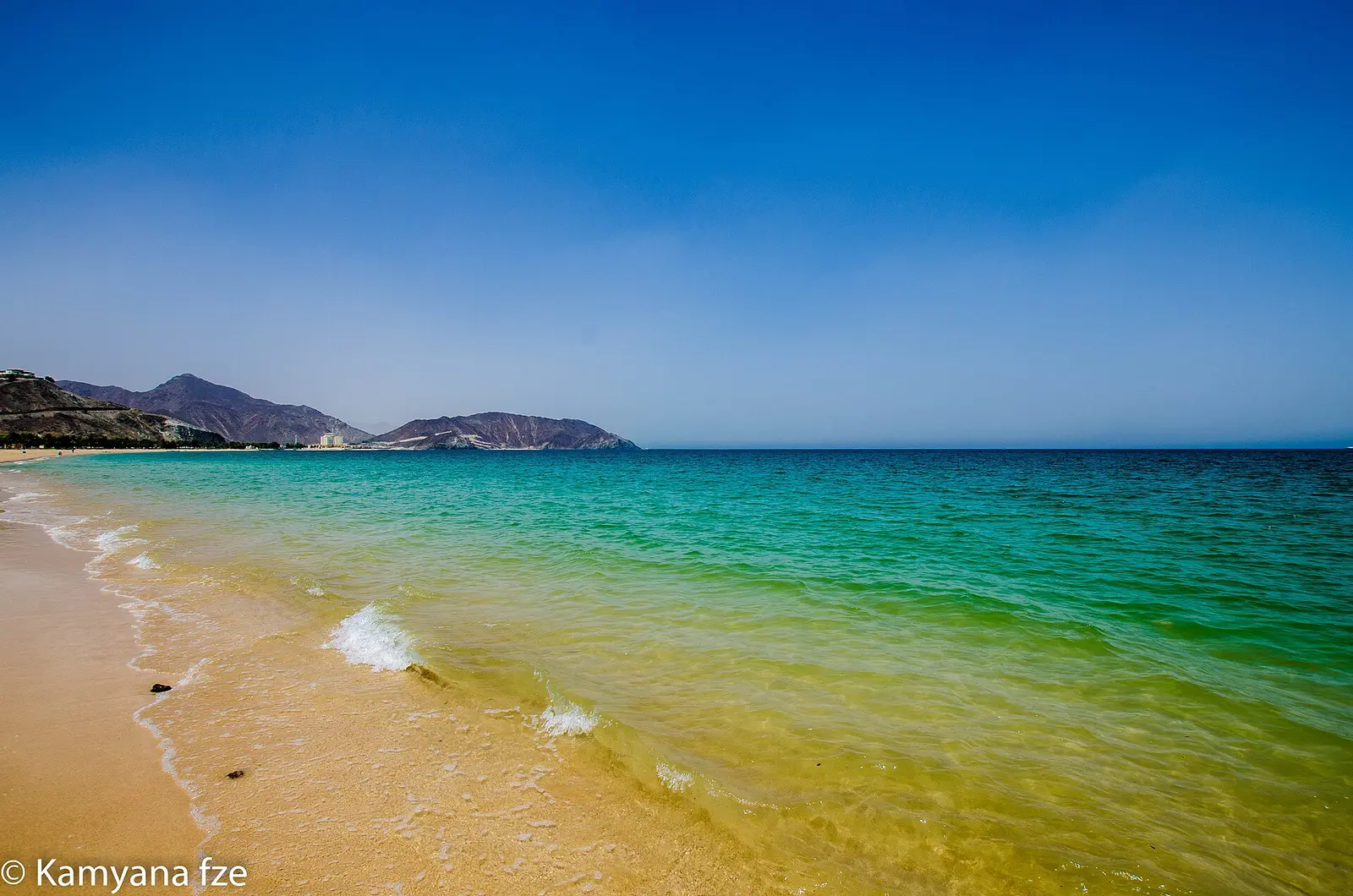 Turquoise water and sand on the Khor Fakkan shoreline