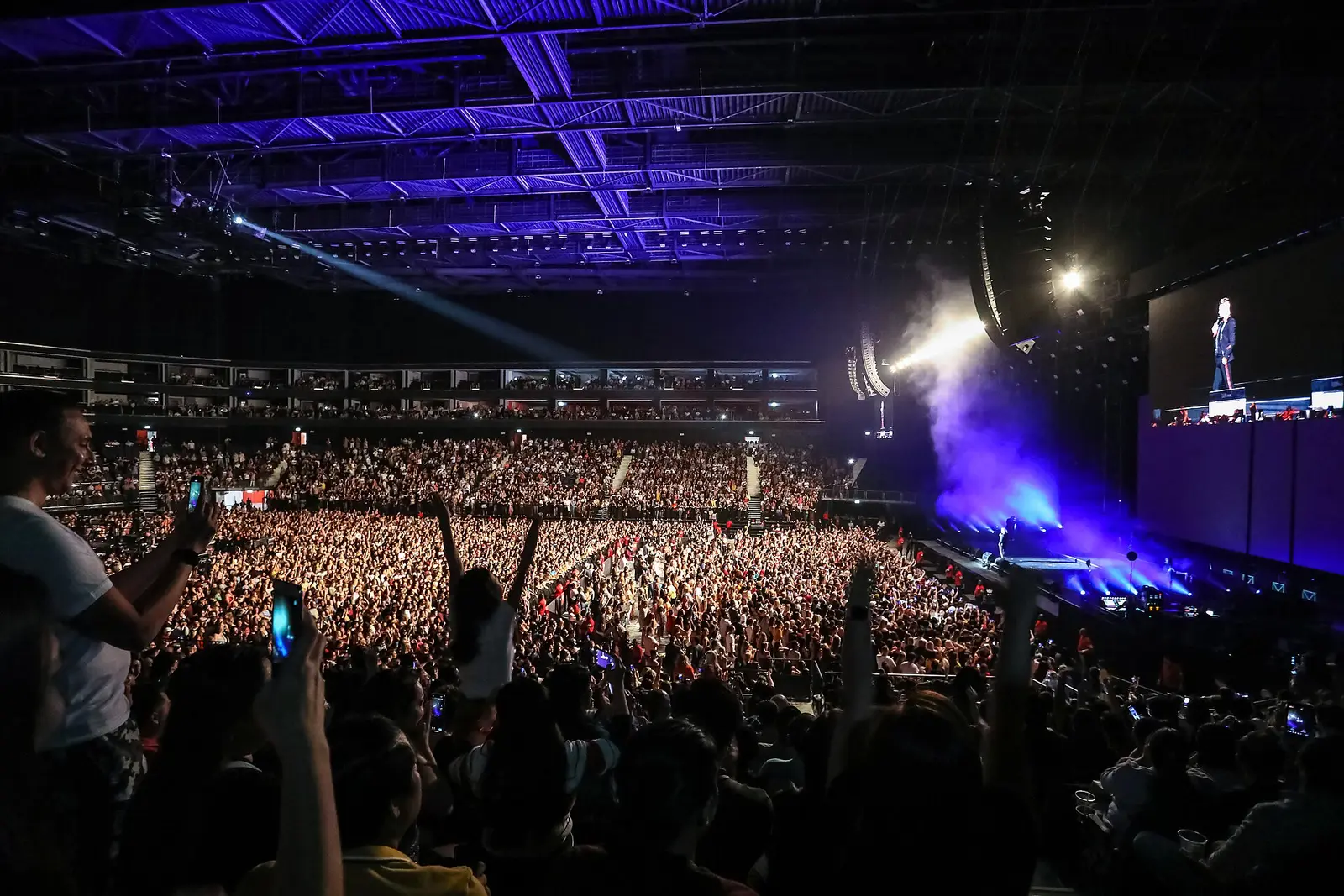 A packed concert at Coca-Cola Arena in Dubai with a lit stage