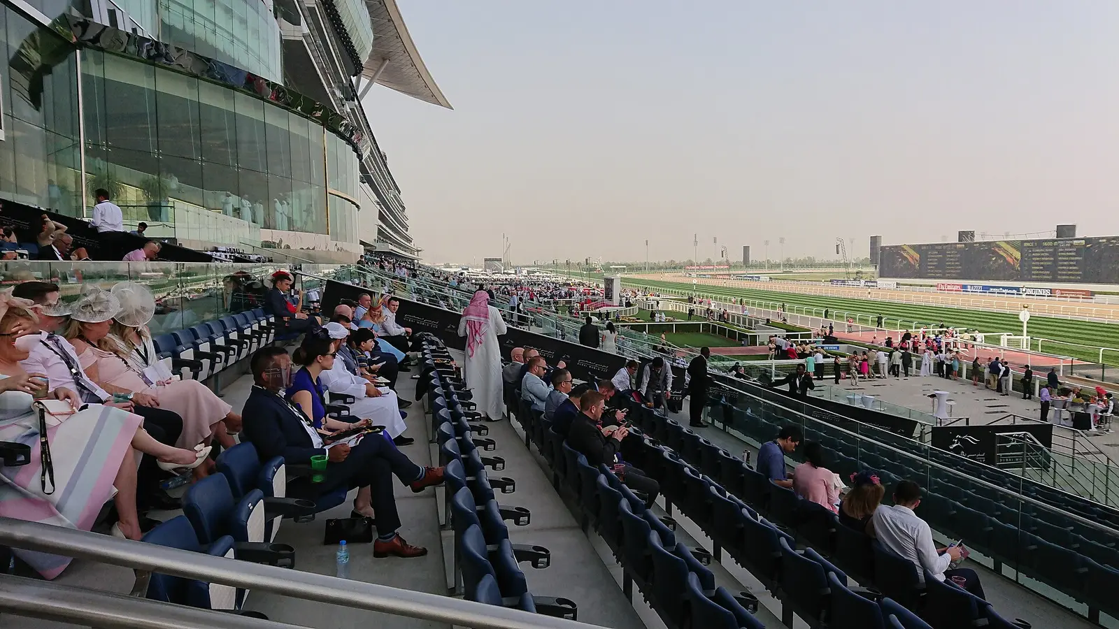 A crowd in the grandstand at Meydan Racecourse during the Dubai World Cup meeting